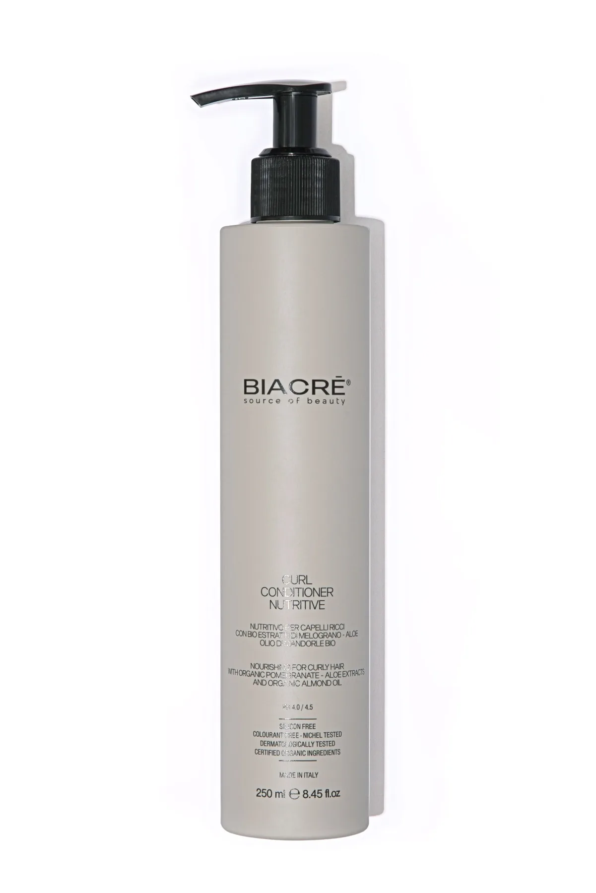 Studio personal care product photography of a haircare bottle with pump dispenser on a clean white background.